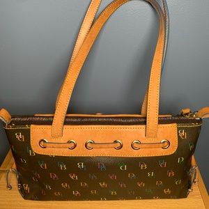 Dooney &Burke 11in wide/7 in tall front tassel purse.Removable interior pocket.